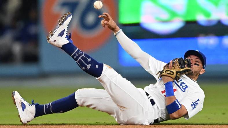 Apr 18, 2023; Los Angeles, California, USA; Los Angeles Dodgers shortstop Miguel Rojas (11) tries to make a play but can   t get New York Mets shortstop Francisco Lindor (12) out at first in the fourth ininng at Dodger Stadium. Mandatory Credit: Jayne Kamin-Oncea-USA TODAY Sports