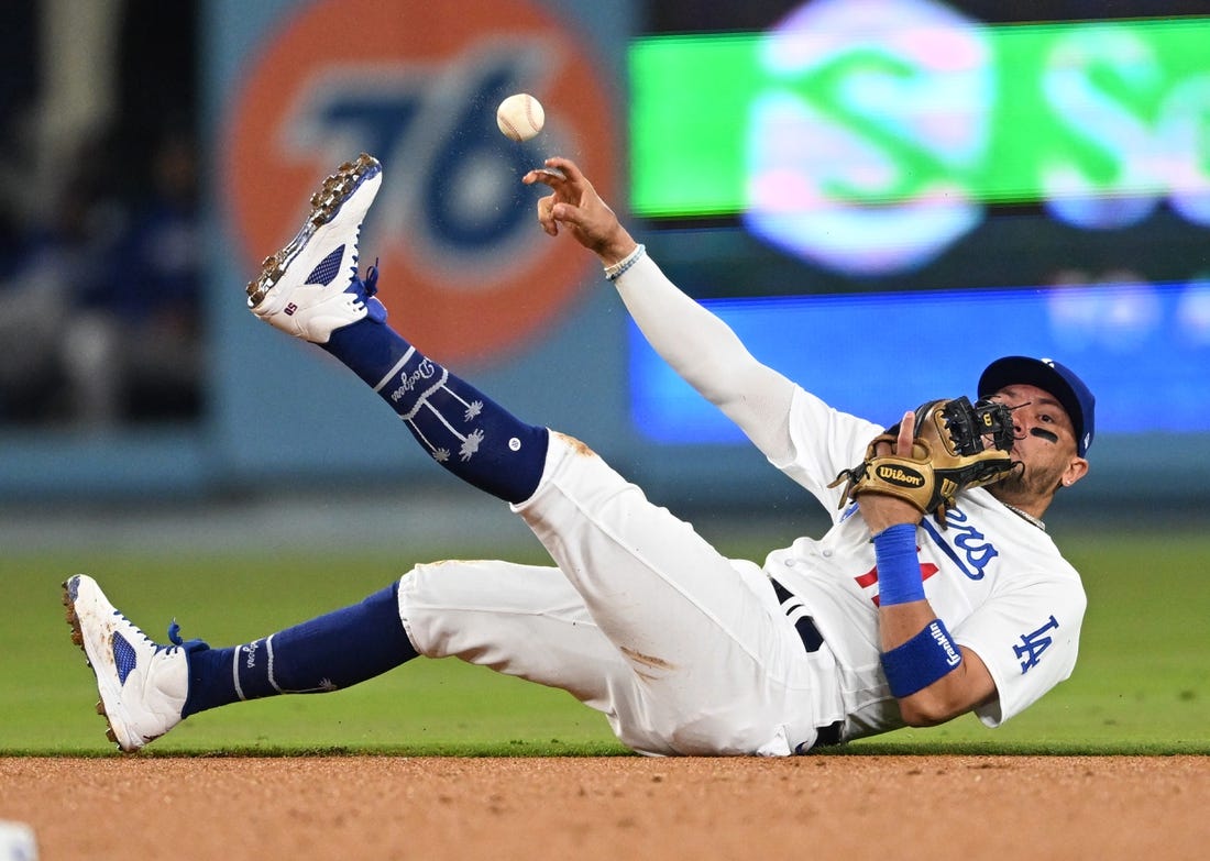 Apr 18, 2023; Los Angeles, California, USA; Los Angeles Dodgers shortstop Miguel Rojas (11) tries to make a play but can   t get New York Mets shortstop Francisco Lindor (12) out at first in the fourth ininng at Dodger Stadium. Mandatory Credit: Jayne Kamin-Oncea-USA TODAY Sports