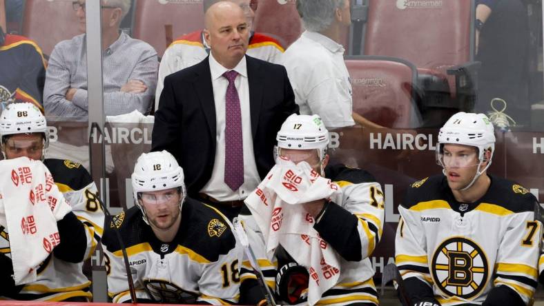 Apr 21, 2023; Sunrise, Florida, USA; Boston Bruins head coach Jim Montgomery looks on from the bench during the third period against the Florida Panthers in game three of the first round of the 2023 Stanley Cup Playoffs at FLA Live Arena. Mandatory Credit: Sam Navarro-USA TODAY Sports