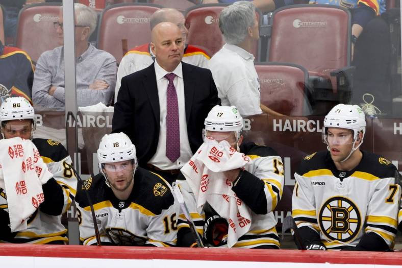 Apr 21, 2023; Sunrise, Florida, USA; Boston Bruins head coach Jim Montgomery looks on from the bench during the third period against the Florida Panthers in game three of the first round of the 2023 Stanley Cup Playoffs at FLA Live Arena. Mandatory Credit: Sam Navarro-USA TODAY Sports