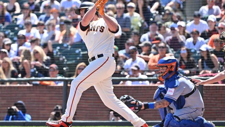 Apr 22, 2023; San Francisco, California, USA; San Francisco Giants designated hitter Darin Ruf (18) hits an RBI single against New York Mets starting pitcher David Peterson (23) during the second inning at Oracle Park. Mandatory Credit: Robert Edwards-USA TODAY Sports