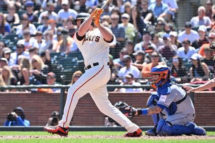 Apr 22, 2023; San Francisco, California, USA; San Francisco Giants designated hitter Darin Ruf (18) hits an RBI single against New York Mets starting pitcher David Peterson (23) during the second inning at Oracle Park. Mandatory Credit: Robert Edwards-USA TODAY Sports