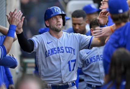 Apr 22, 2023; Anaheim, California, USA;  Kansas City Royals third baseman Hunter Dozier (17) is greeted in the dugout after scoring on a single by shortstop Bobby Witt Jr. (7) in the third inning against the Los Angeles Angels at Angel Stadium. Mandatory Credit: Jayne Kamin-Oncea-USA TODAY Sports