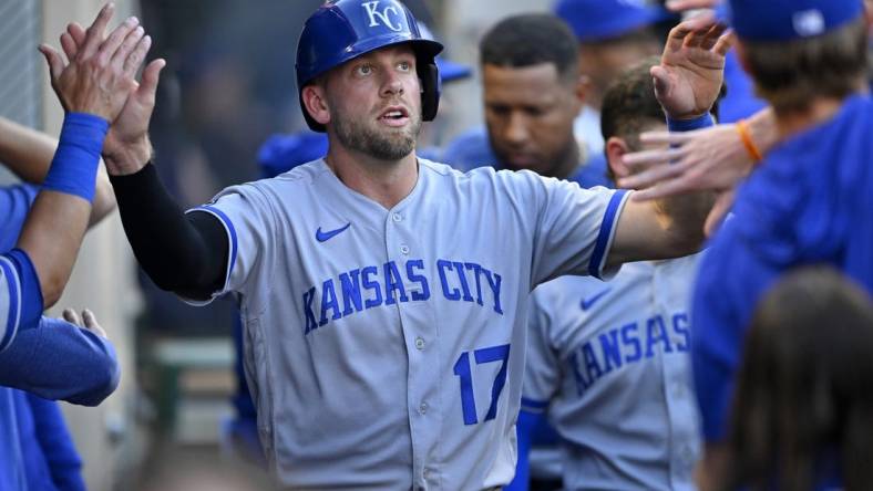 Apr 22, 2023; Anaheim, California, USA;  Kansas City Royals third baseman Hunter Dozier (17) is greeted in the dugout after scoring on a single by shortstop Bobby Witt Jr. (7) in the third inning against the Los Angeles Angels at Angel Stadium. Mandatory Credit: Jayne Kamin-Oncea-USA TODAY Sports