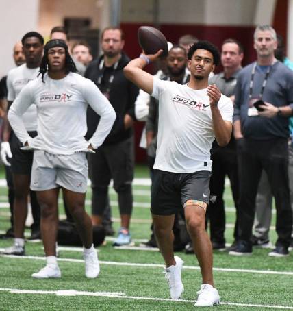 Bryce Young throws during Alabama's pro day. Carolina Panthers head coach Frank Reich and his assistants look on.

Syndication Tuscaloosa News