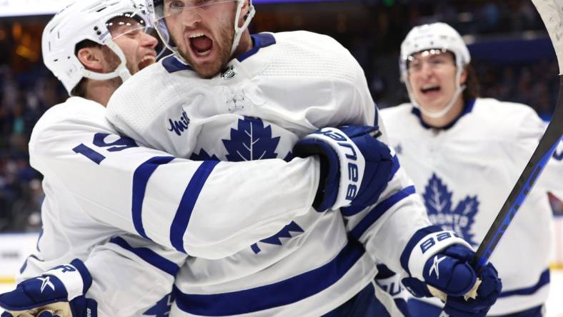 Apr 24, 2023; Tampa, Florida, USA;Toronto Maple Leafs center Alexander Kerfoot (15) celebrates after he scored the game-winning goal against the Tampa Bay Lightning in overtime of game four of the first round of the 2023 Stanley Cup Playoffs at Amalie Arena. Mandatory Credit: Kim Klement-USA TODAY Sports