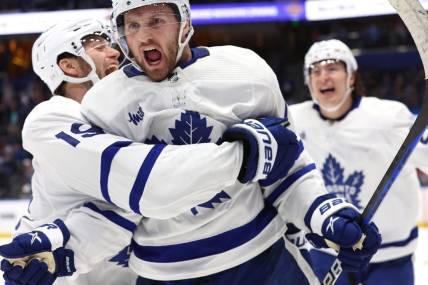 Apr 24, 2023; Tampa, Florida, USA;Toronto Maple Leafs center Alexander Kerfoot (15) celebrates after he scored the game-winning goal against the Tampa Bay Lightning in overtime of game four of the first round of the 2023 Stanley Cup Playoffs at Amalie Arena. Mandatory Credit: Kim Klement-USA TODAY Sports