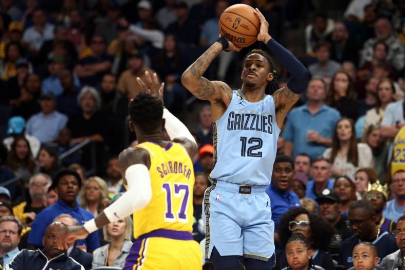 Apr 26, 2023; Memphis, Tennessee, USA; Memphis Grizzlies guard Ja Morant (12) shoots a three point shot as Los Angeles Lakers guard Dennis Schroder (17) defends during the second half of game five of the 2023 NBA playoffs at FedExForum. Mandatory Credit: Petre Thomas-USA TODAY Sports