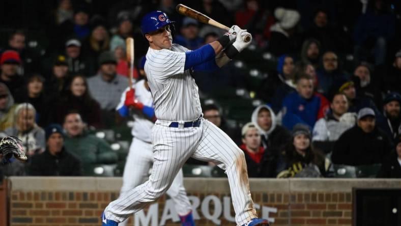 Apr 25, 2023; Chicago, Illinois, USA;  Chicago Cubs catcher Yan Gomes (15) hits an RBI single against the San Diego Padres during the eighth inning  at Wrigley Field. Mandatory Credit: Matt Marton-USA TODAY Sports