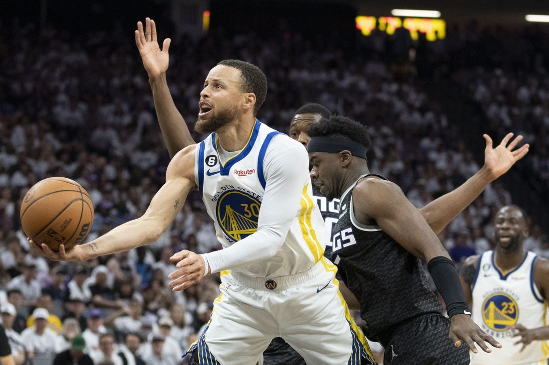 April 30, 2023; Sacramento, California, USA; Golden State Warriors guard Stephen Curry (30) shoots the basketball against Sacramento Kings forward Harrison Barnes (40) and guard Terence Davis (3) during the third quarter in game seven of the 2023 NBA playoffs first round at Golden 1 Center. Mandatory Credit: Kyle Terada-USA TODAY Sports