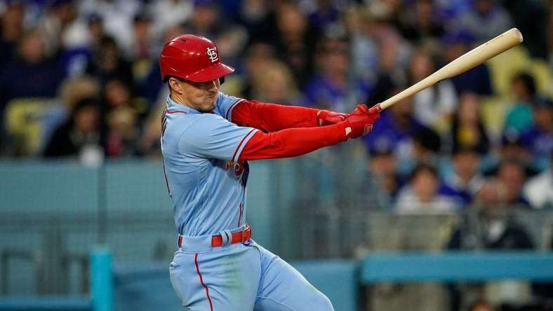 Apr 29, 2023; Los Angeles, California, USA; St. Louis Cardinals shortstop Tommy Edman (19) hits a single against the Los Angeles Dodgers during the sixth inning at Dodger Stadium. Mandatory Credit: Lucas Peltier-USA TODAY Sports