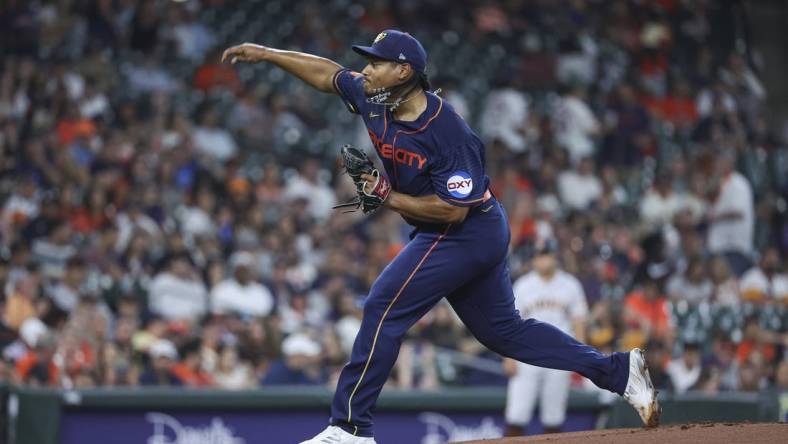 May 1, 2023; Houston, Texas, USA; Houston Astros starting pitcher Luis Garcia (77) delivers a pitch during the first inning aSan Francisco Giants at Minute Maid Park. Mandatory Credit: Troy Taormina-USA TODAY Sports