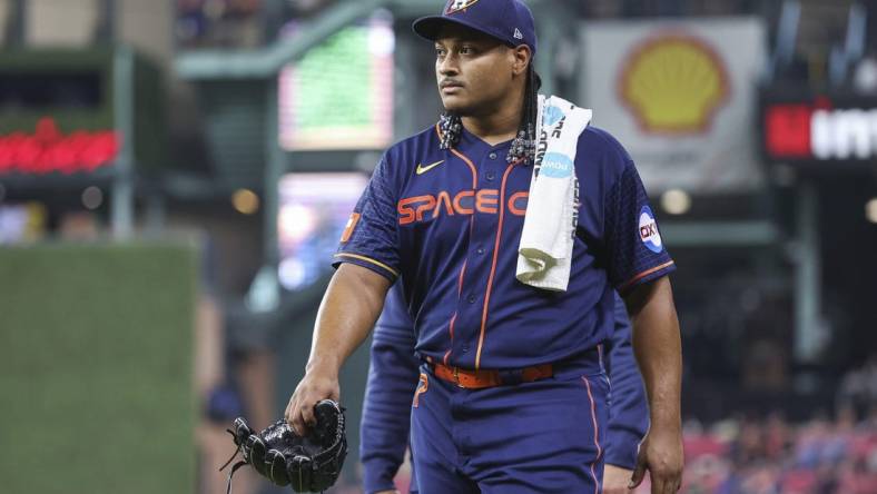 May 1, 2023; Houston, Texas, USA; Houston Astros starting pitcher Luis Garcia (77) walks to the dugout before the game against the San Francisco Giants at Minute Maid Park. Mandatory Credit: Troy Taormina-USA TODAY Sports