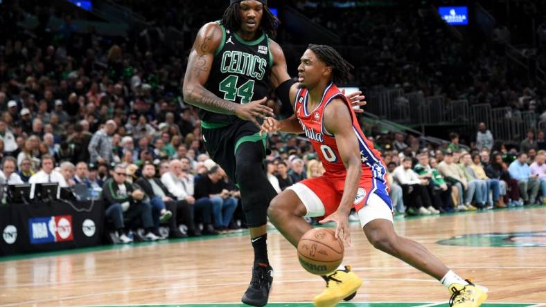 May 1, 2023; Boston, Massachusetts, USA; Philadelphia 76ers guard Tyrese Maxey (0) controls the ball while Boston Celtics center Robert Williams III (44) defends in the first half during game one of the 2023 NBA playoffs at TD Garden. Mandatory Credit: Bob DeChiara-USA TODAY Sports