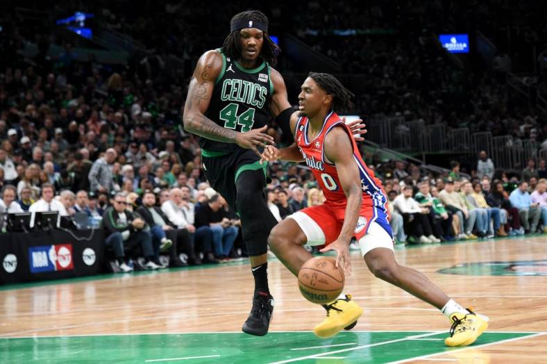 May 1, 2023; Boston, Massachusetts, USA; Philadelphia 76ers guard Tyrese Maxey (0) controls the ball while Boston Celtics center Robert Williams III (44) defends in the first half during game one of the 2023 NBA playoffs at TD Garden. Mandatory Credit: Bob DeChiara-USA TODAY Sports