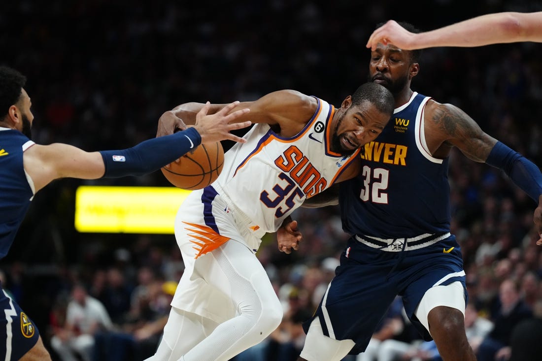 May 1, 2023; Denver, Colorado, USA; Phoenix Suns forward Kevin Durant (35) drives at Denver Nuggets forward Jeff Green (32) in the first half during game two of the 2023 NBA playoffs at Ball Arena. Mandatory Credit: Ron Chenoy-USA TODAY Sports