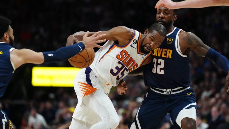 May 1, 2023; Denver, Colorado, USA; Phoenix Suns forward Kevin Durant (35) drives at Denver Nuggets forward Jeff Green (32) in the first half during game two of the 2023 NBA playoffs at Ball Arena. Mandatory Credit: Ron Chenoy-USA TODAY Sports