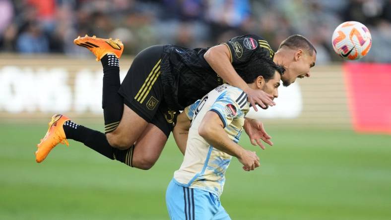 May 2, 2023; Los Angeles, CA, USA; LAFC defender Aaron Long (33) and Philadelphia Union forward Julian Carranza (9) battle for the ball in the first half at BMO Stadium. Mandatory Credit: Kirby Lee-USA TODAY Sports