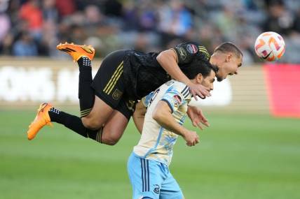 May 2, 2023; Los Angeles, CA, USA; LAFC defender Aaron Long (33) and Philadelphia Union forward Julian Carranza (9) battle for the ball in the first half at BMO Stadium. Mandatory Credit: Kirby Lee-USA TODAY Sports