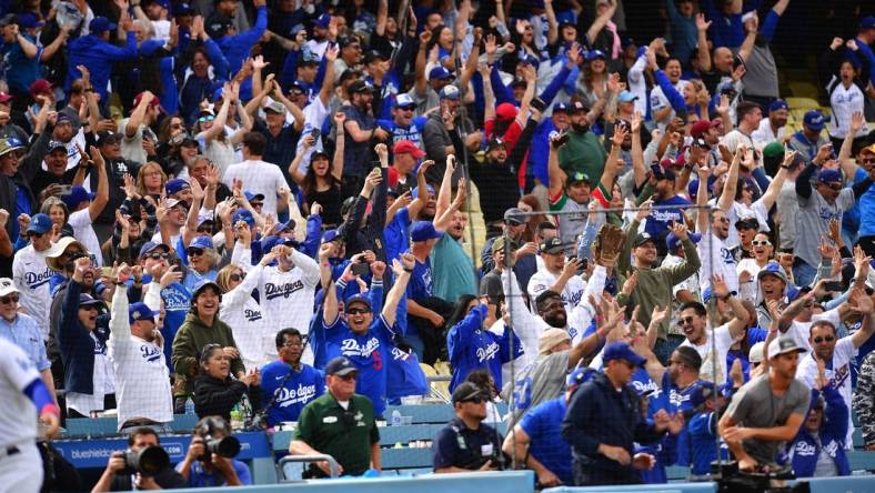 May 3, 2023; Los Angeles, California, USA; Fans cheer after Los Angeles Dodgers third baseman Max Muncy (13) hits a walk off grand slam home run against the Philadelphia Phillies during the ninth inning at Dodger Stadium. Mandatory Credit: Gary A. Vasquez-USA TODAY Sports