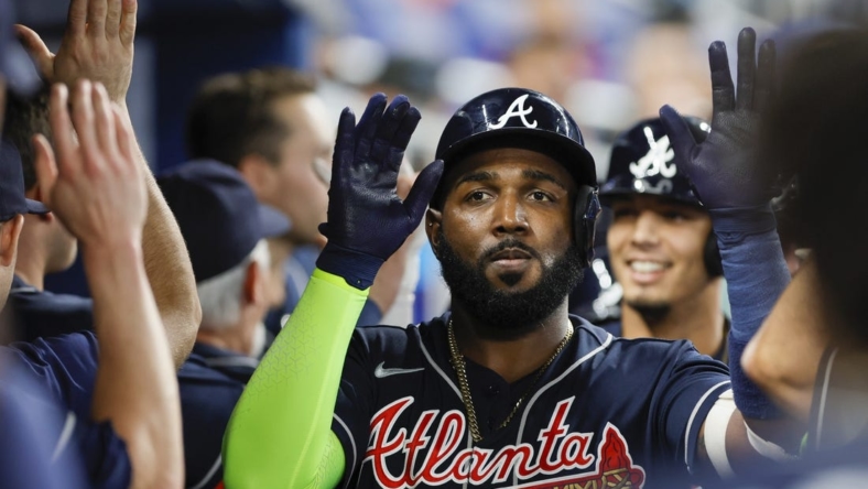 May 3, 2023; Miami, Florida, USA; Atlanta Braves designated hitter Marcell Ozuna (20) celebrates with teammates after hitting a grand slam during the second inning against the Miami Marlins at loanDepot Park. Mandatory Credit: Sam Navarro-USA TODAY Sports