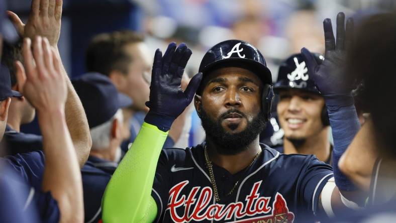 May 3, 2023; Miami, Florida, USA; Atlanta Braves designated hitter Marcell Ozuna (20) celebrates with teammates after hitting a grand slam during the second inning against the Miami Marlins at loanDepot Park. Mandatory Credit: Sam Navarro-USA TODAY Sports