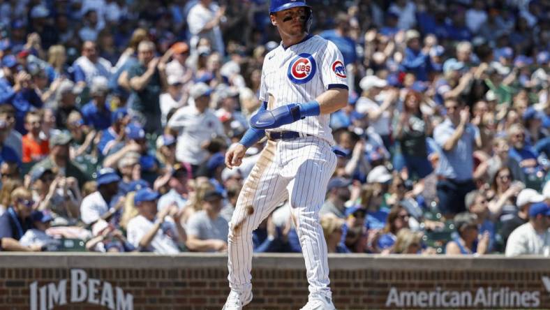 May 5, 2023; Chicago, Illinois, USA; Chicago Cubs second baseman Nico Hoerner (2) scores against the Miami Marlins during the first inning at Wrigley Field. Mandatory Credit: Kamil Krzaczynski-USA TODAY Sports