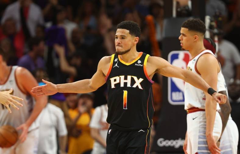 May 5, 2023; Phoenix, Arizona, USA; Phoenix Suns guard Devin Booker (1) celebrates with teammates against the Denver Nuggets in the second half during game three of the 2023 NBA playoffs at Footprint Center. Mandatory Credit: Mark J. Rebilas-USA TODAY Sports