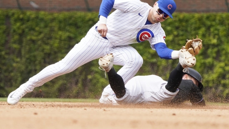 May 6, 2023; Chicago, Illinois, USA; Chicago Cubs second baseman Nico Hoerner (2) tags out Miami Marlins shortstop Jon Berti (5) at second base on a steal attempt of second base during the fifth inning at Wrigley Field. Mandatory Credit: David Banks-USA TODAY Sports