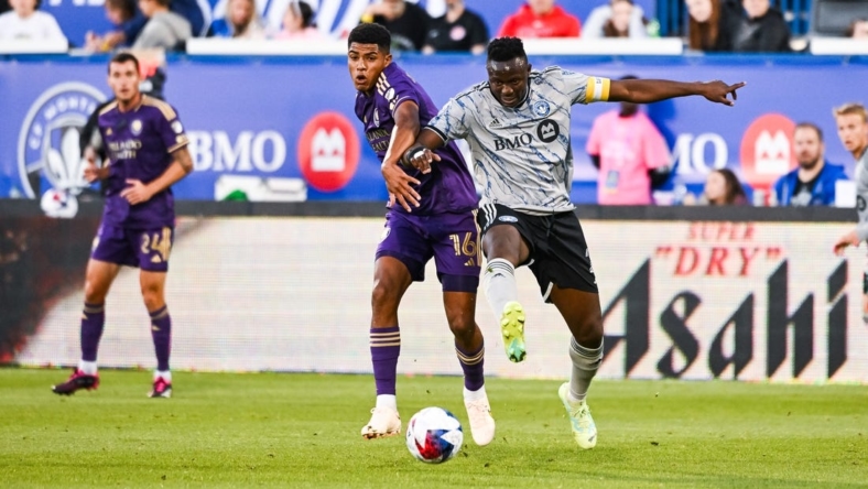 May 6, 2023; Montreal, Quebec, CAN; CF Montreal midfielder Victor Wanyama (2) defends the ball against Orlando City SC midfielder Wilder Cartagena (16) during the first half at Stade Saputo. Mandatory Credit: David Kirouac-USA TODAY Sports