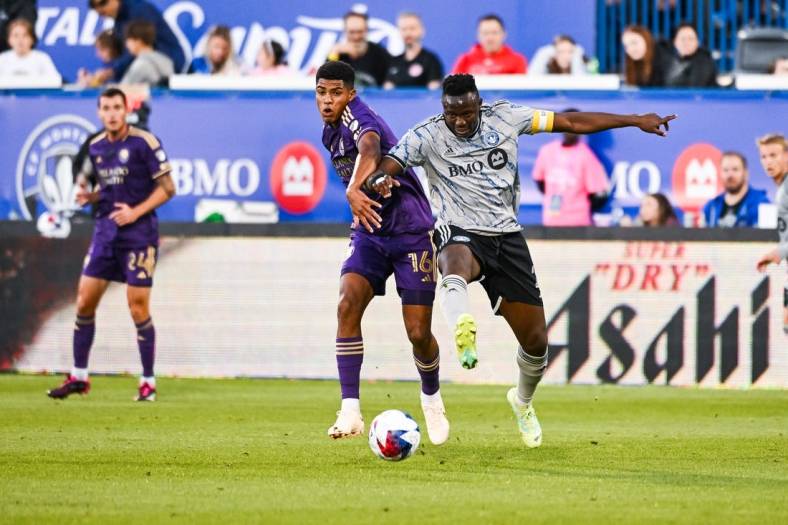 May 6, 2023; Montreal, Quebec, CAN; CF Montreal midfielder Victor Wanyama (2) defends the ball against Orlando City SC midfielder Wilder Cartagena (16) during the first half at Stade Saputo. Mandatory Credit: David Kirouac-USA TODAY Sports