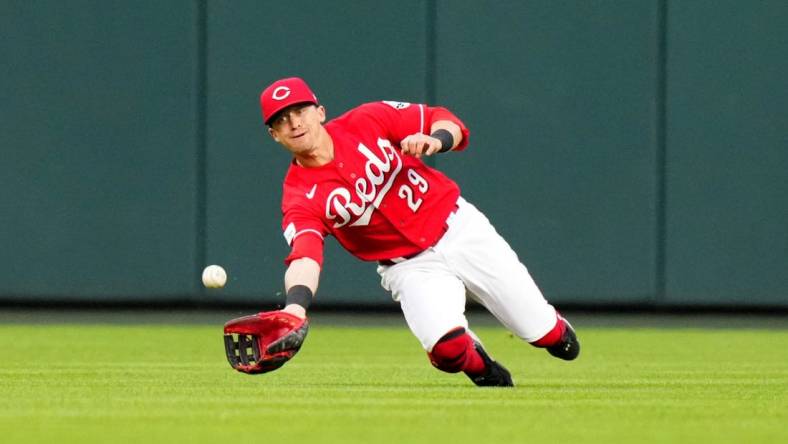 Cincinnati Reds center fielder TJ Friedl (29) completes a diving catch in the fifth inning during a baseball game between the Chicago White Sox and the Cincinnati Reds, Saturday, May 6, 2023, at Great American Ball Park in Cincinnati.