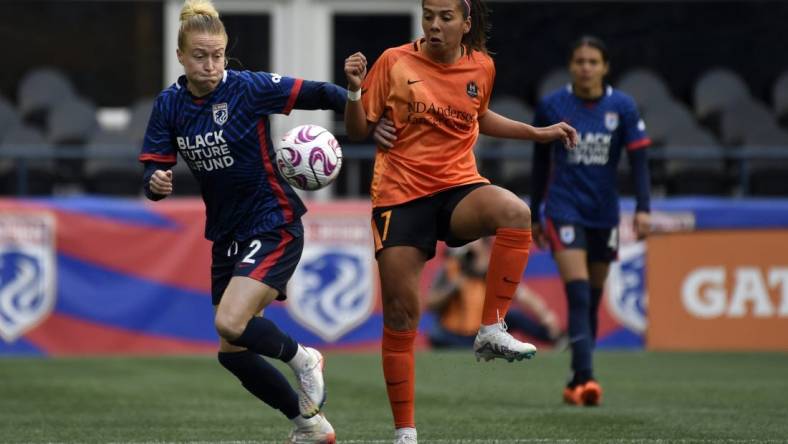 May 6, 2023; Seattle, Washington, USA; OL Reign defender Emily Sonnett (2) and Houston Dash forward Maria Sanchez (7) both go for the ball during the first half at Lumen Field. Mandatory Credit: Michael Thomas Shroyer-USA TODAY Sports