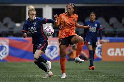 May 6, 2023; Seattle, Washington, USA; OL Reign defender Emily Sonnett (2) and Houston Dash forward Maria Sanchez (7) both go for the ball during the first half at Lumen Field. Mandatory Credit: Michael Thomas Shroyer-USA TODAY Sports