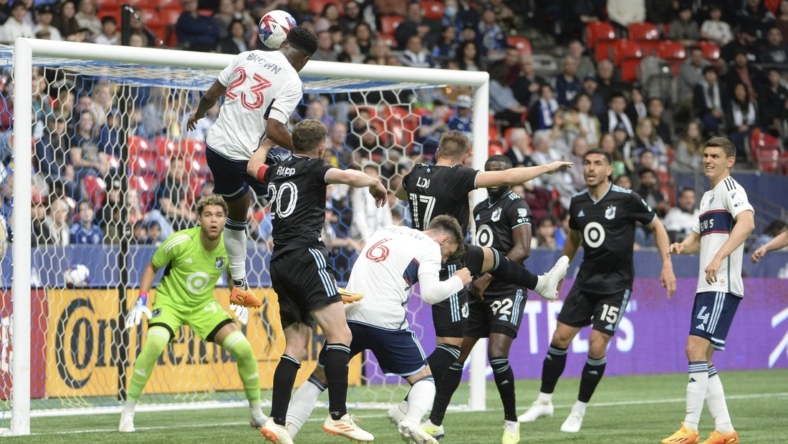 May 6, 2023; Vancouver, British Columbia, CAN;  Vancouver Whitecaps FC defender Javain Brown (23) heads the ball towards the net of Minnesota United FC goalkeeper Dayne St. Clair (97) during the first half at BC Place.  Mandatory Credit: Anne-Marie Sorvin-USA TODAY Sports