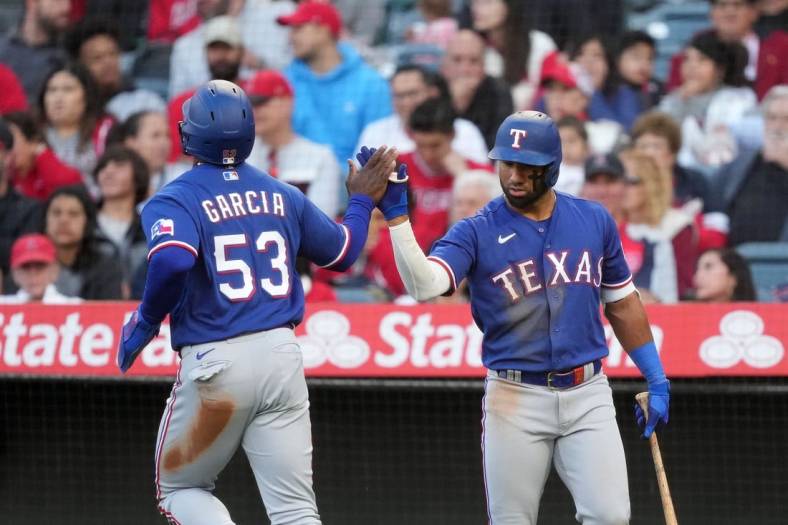 May 6, 2023; Anaheim, California, USA; Texas Rangers right fielder Adolis Garcia (53) celebrates with third baseman Josh Jung (6) after scoring in the fourth inning against the Los Angeles Angels at Angel Stadium. Mandatory Credit: Kirby Lee-USA TODAY Sports