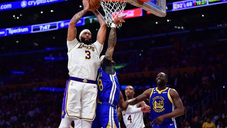 May 6, 2023; Los Angeles, California, USA; Los Angeles Lakers forward Anthony Davis (3) gets the rebound against Golden State Warriors guard Gary Payton II (8) and forward Draymond Green (23) during the second half in game three of the 2023 NBA playoffs at Crypto.com Arena. Mandatory Credit: Gary A. Vasquez-USA TODAY Sports