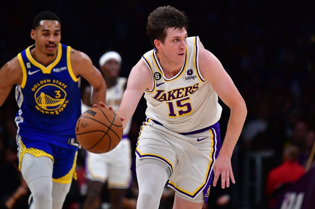 May 6, 2023; Los Angeles, California, USA; Los Angeles Lakers guard Austin Reaves (15) moves the ball ahead of Golden State Warriors guard Jordan Poole (3) during the first half in game three of the 2023 NBA playoffs at Crypto.com Arena. Mandatory Credit: Gary A. Vasquez-USA TODAY Sports