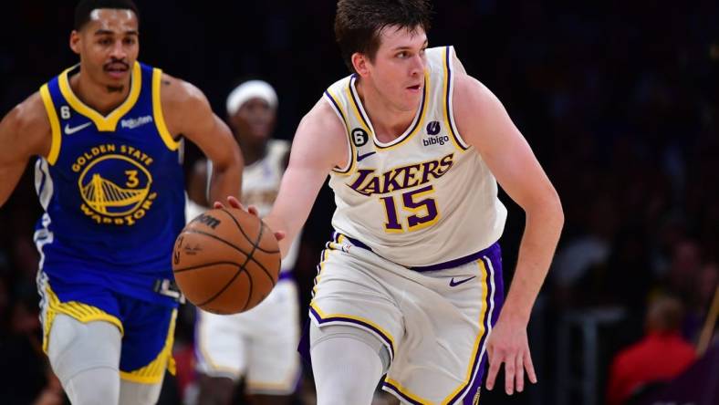 May 6, 2023; Los Angeles, California, USA; Los Angeles Lakers guard Austin Reaves (15) moves the ball ahead of Golden State Warriors guard Jordan Poole (3) during the first half in game three of the 2023 NBA playoffs at Crypto.com Arena. Mandatory Credit: Gary A. Vasquez-USA TODAY Sports