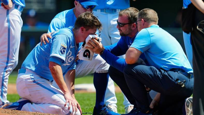 May 7, 2023; Kansas City, Missouri, USA; Kansas City Royals relief pitcher Ryan Yarbrough (48) is attended to by medical staff after being hit by a line drive off the bat of Oakland Athletics first baseman Ryan Noda (not pictured) during the sixth inning at Kauffman Stadium. Mandatory Credit: Jay Biggerstaff-USA TODAY Sports