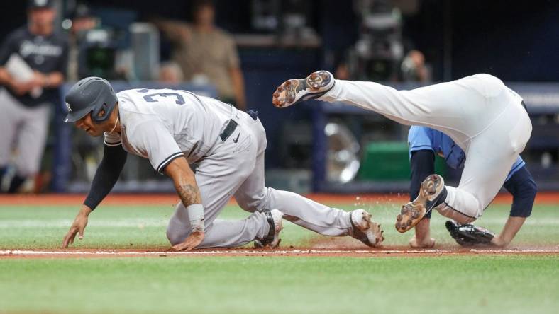 May 7, 2023; St. Petersburg, Florida, USA;  New York Yankees left fielder Aaron Hicks (31) collides with Tampa Bay Rays relief pitcher Garrett Cleavinger (60) in the tenth inning at Tropicana Field. Mandatory Credit: Nathan Ray Seebeck-USA TODAY Sports