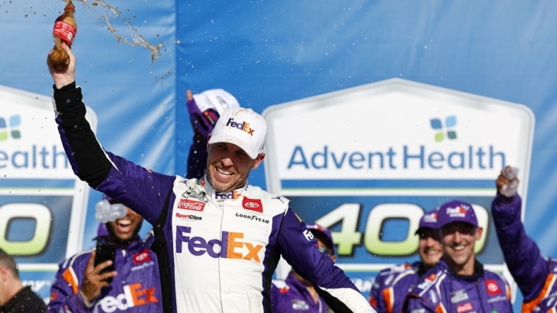 May 7, 2023; Kansas City, Kansas, USA; NASCAR Cup Series driver Denny Hamlin (11) reacts after winning the AdventHealth 400 at Kansas Speedway. Mandatory Credit: Mike Dinovo-USA TODAY Sports