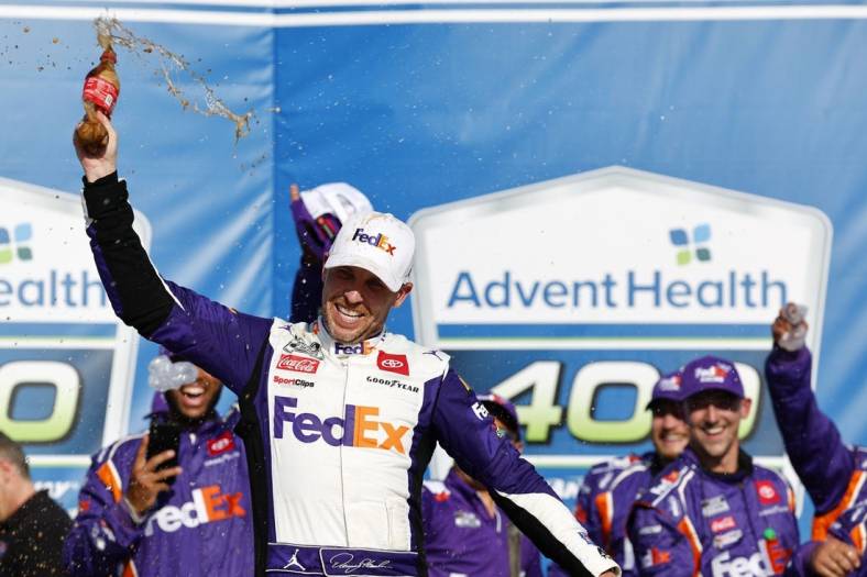 May 7, 2023; Kansas City, Kansas, USA; NASCAR Cup Series driver Denny Hamlin (11) reacts after winning the AdventHealth 400 at Kansas Speedway. Mandatory Credit: Mike Dinovo-USA TODAY Sports