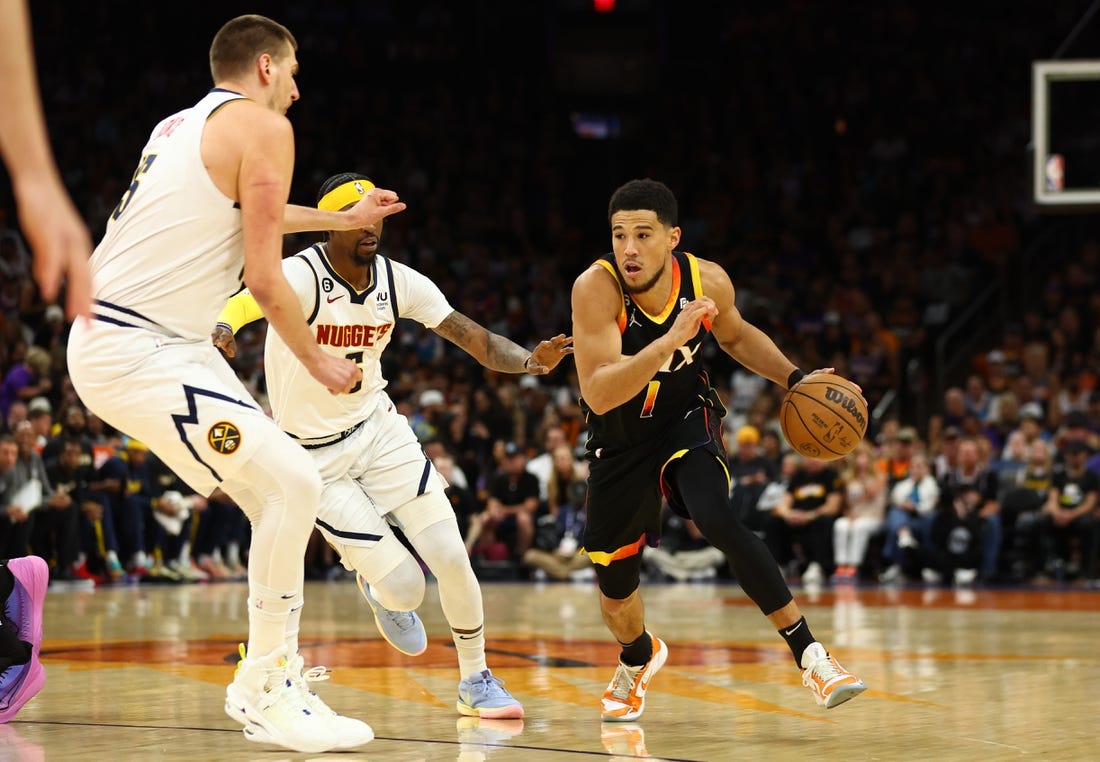 May 7, 2023; Phoenix, Arizona, USA; Phoenix Suns guard Devin Booker (1) against the Denver Nuggets in the first half during game four of the 2023 NBA playoffs at Footprint Center. Mandatory Credit: Mark J. Rebilas-USA TODAY Sports