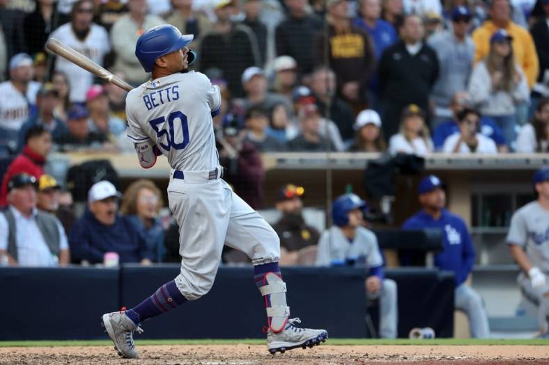 May 7, 2023; San Diego, California, USA;  Los Angeles Dodgers right fielder Mookie Betts (50) hits a home run during the ninth inning against the San Diego Padres at Petco Park. Mandatory Credit: Kiyoshi Mio-USA TODAY Sports