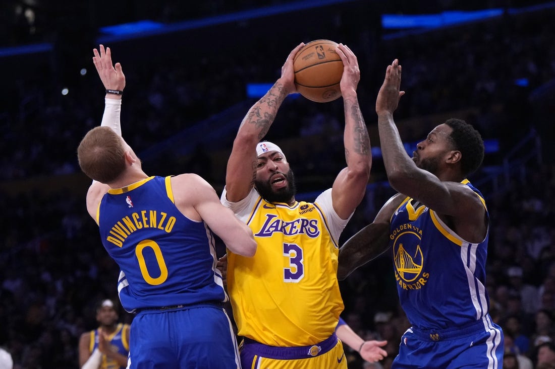 May 8, 2023; Los Angeles, California, USA; Los Angeles Lakers forward Anthony Davis (3) is defended by Golden State Warriors guard Donte DiVincenzo (0) and forward JaMychal Green (1) in the first half during game four of the 2023 NBA playoffs at Crypto.com Arena. Mandatory Credit: Kirby Lee-USA TODAY Sports