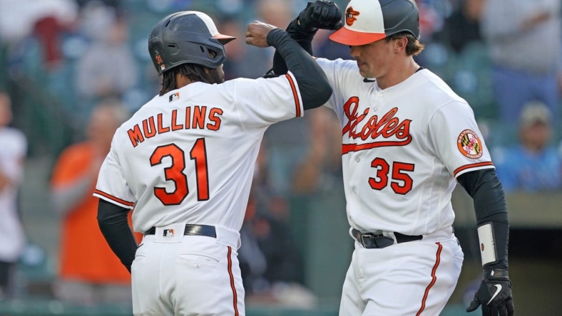 May 9, 2023; Baltimore, Maryland, USA; Baltimore Orioles catcher Adley Rutschman (35) greeted by outfielder Cedric Mullins (31) who scored on his two run home run in the third inning against the Tampa Bay Rays at Oriole Park at Camden Yards. Mandatory Credit: Mitch Stringer-USA TODAY Sports