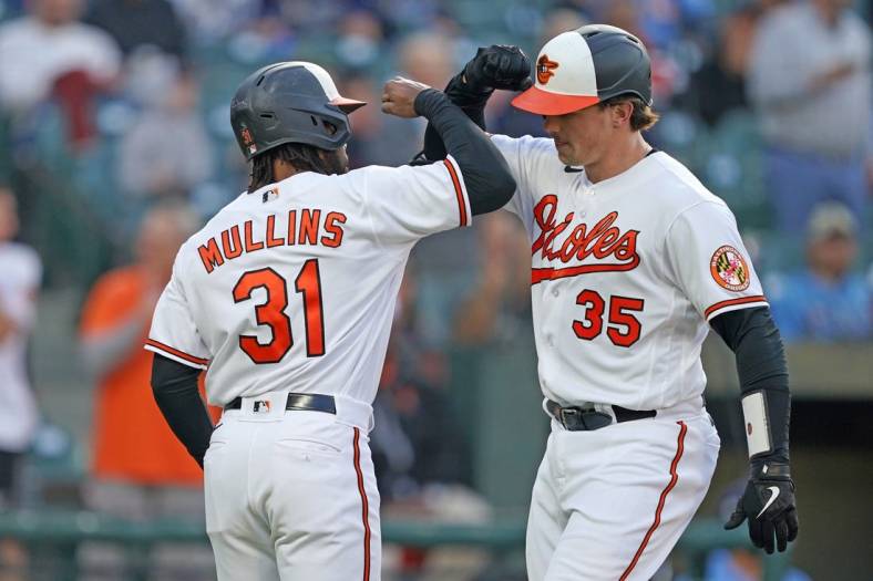 May 9, 2023; Baltimore, Maryland, USA; Baltimore Orioles catcher Adley Rutschman (35) greeted by outfielder Cedric Mullins (31) who scored on his two run home run in the third inning against the Tampa Bay Rays at Oriole Park at Camden Yards. Mandatory Credit: Mitch Stringer-USA TODAY Sports