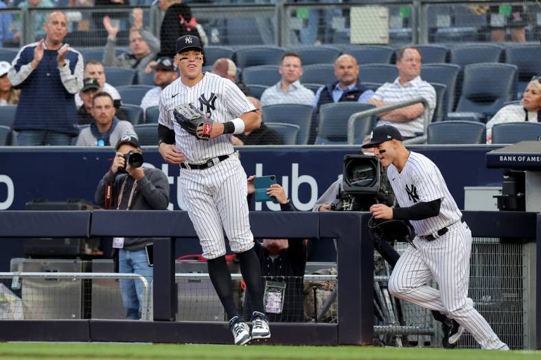 May 9, 2023; Bronx, New York, USA; New York Yankees right fielder Aaron Judge (99) and first baseman Anthony Rizzo (48) take the field for the first inning against the Oakland Athletics at Yankee Stadium. Mandatory Credit: Brad Penner-USA TODAY Sports