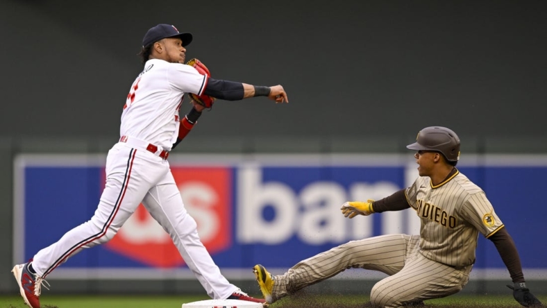 May 9, 2023; Minneapolis, Minnesota, USA;  Minnesota Twins infielder Jorge Polanco (11) throws over San Diego Padres outfielder Juan Soto (22) to complete a double play during the second inning at Target Field. Mandatory Credit: Nick Wosika-USA TODAY Sports